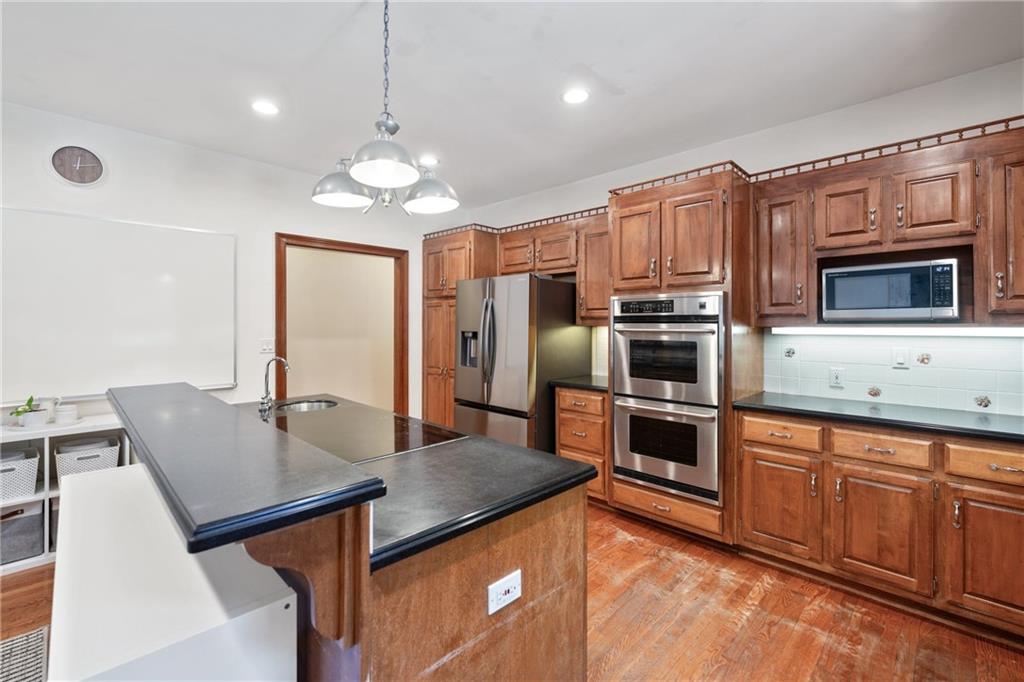 422 Blessings Lane Nicholson, GA 30565 - Photo 21 of 90 a kitchen with stainless steel appliances granite countertop a sink refrigerator and microwave