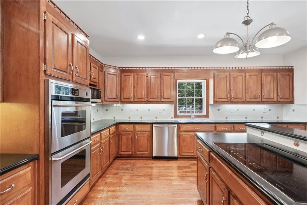 422 Blessings Lane Nicholson, GA 30565 - Photo 23 of 90 a kitchen with stainless steel appliances a stove sink and cabinets