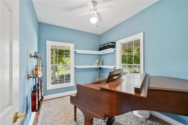 a view of an empty room with wooden floor and a bathroom