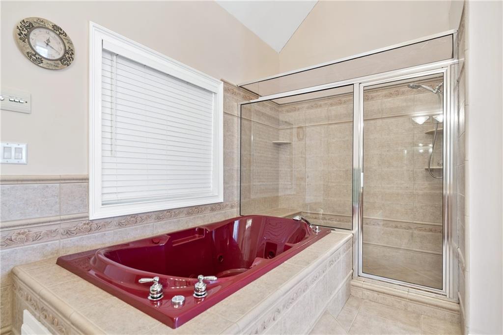 422 Blessings Lane Nicholson, GA 30565 - Photo 38 of 90 a bath room with a bath tub and a shower