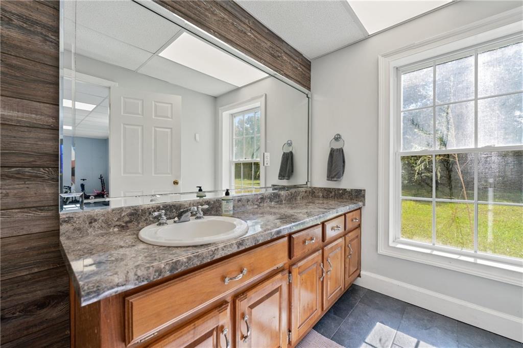 422 Blessings Lane Nicholson, GA 30565 - Photo 64 of 90 a bathroom with a granite countertop sink and a large mirror