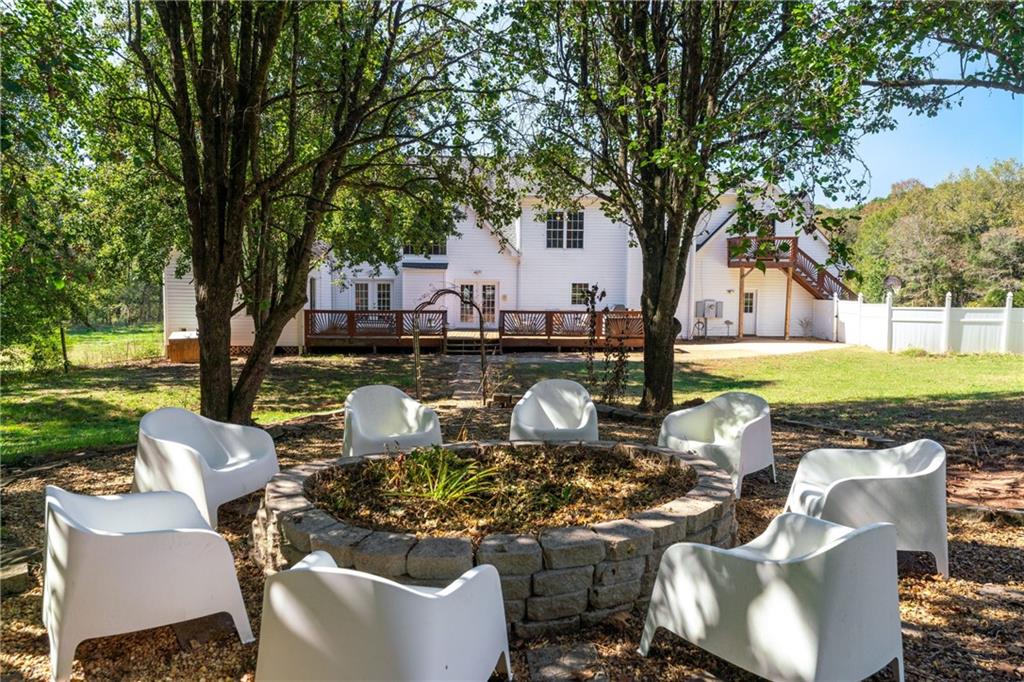 422 Blessings Lane Nicholson, GA 30565 - Photo 66 of 90 a view of a patio with couches chairs and a fire pit