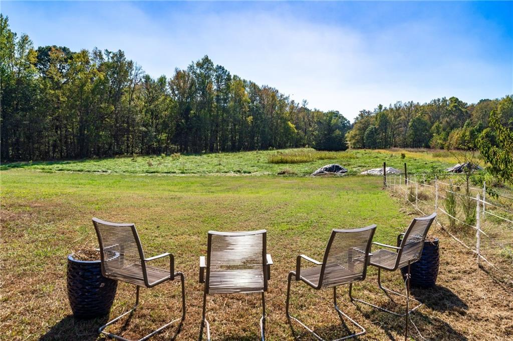 422 Blessings Lane Nicholson, GA 30565 - Photo 75 of 90 a view of a table and chairs in the garden