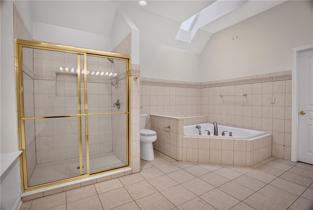 502 Farndale Road Pittsburgh, PA 15215 - Photo 27 of 50 The primary bathroom features a jetted tub and walk-in tile shower.