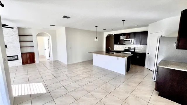 a kitchen with stainless steel appliances a refrigerator sink and cabinets