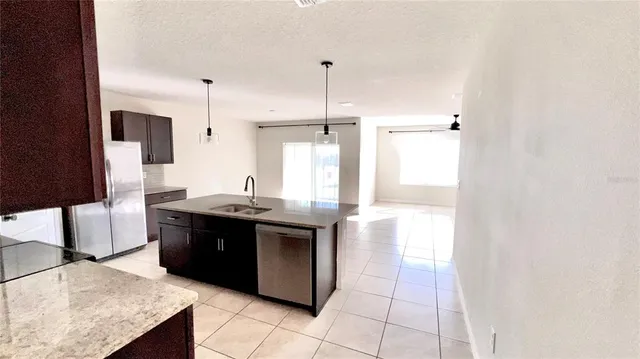 a kitchen with stainless steel appliances granite countertop a sink and a stove