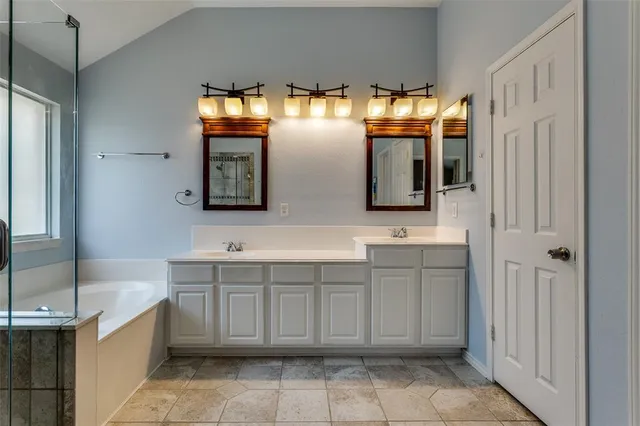 a bathroom with a double vanity sink and a mirror