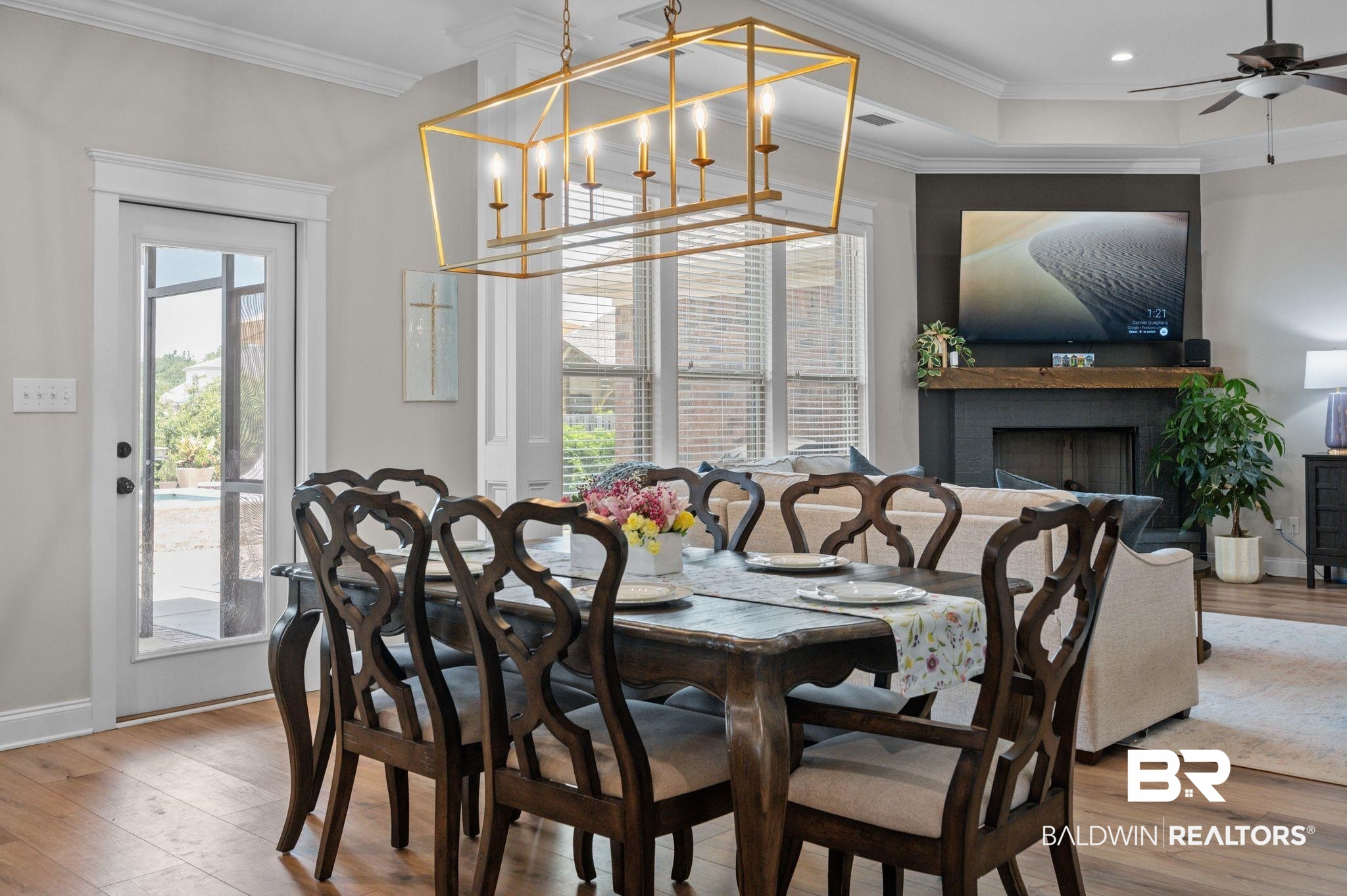 409 Fortune Drive Fairhope, AL 36532 - Photo 8 of 42 Open-concept dining area featuring wood-finish flooring, a contemporary rectangular chandelier, and a glass-paneled door
