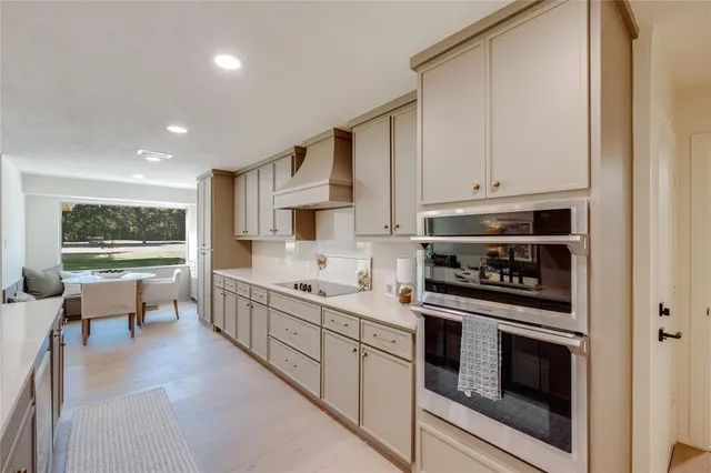 a kitchen with sink stove and cabinets
