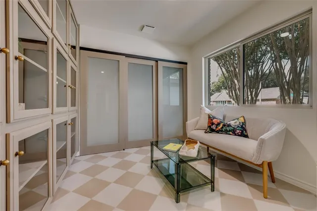 a large white kitchen with cabinets and a wooden floor