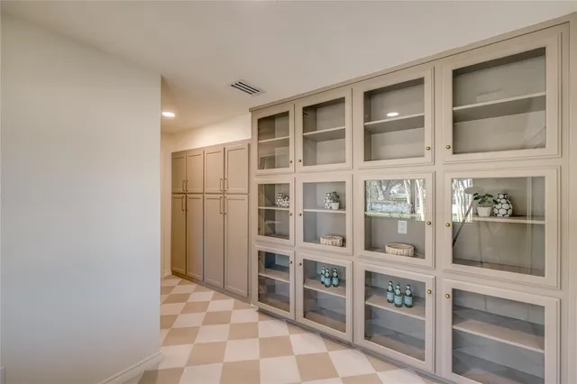 a living room with furniture a large window and a table