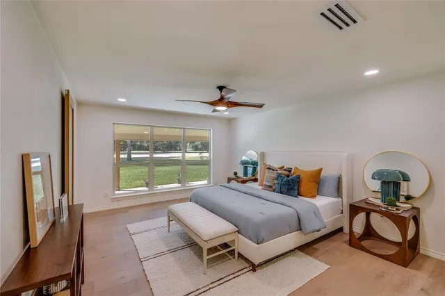 a view of a livingroom with a ceiling fan and window