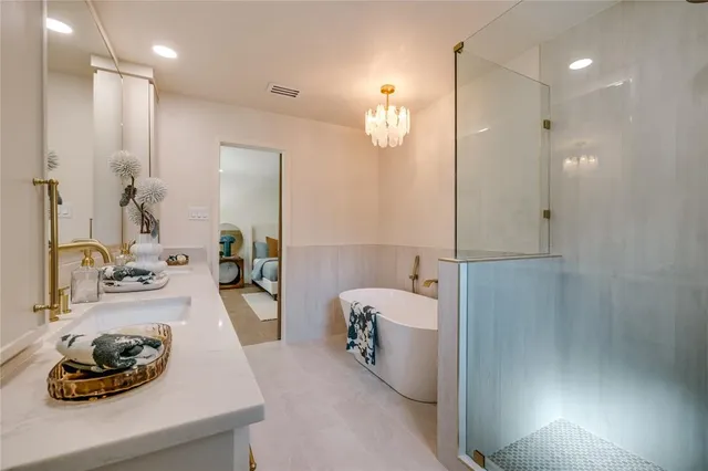 a bathroom with a tub sink and mirror