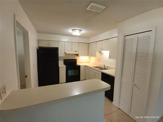 a kitchen with a refrigerator and a sink