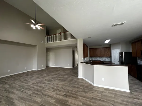 a view of kitchen with sink and wooden floor
