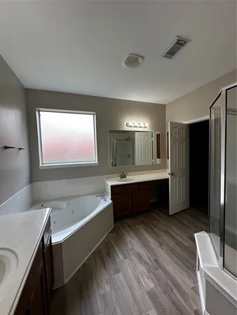 a large spacious bathroom with a large tub and sink