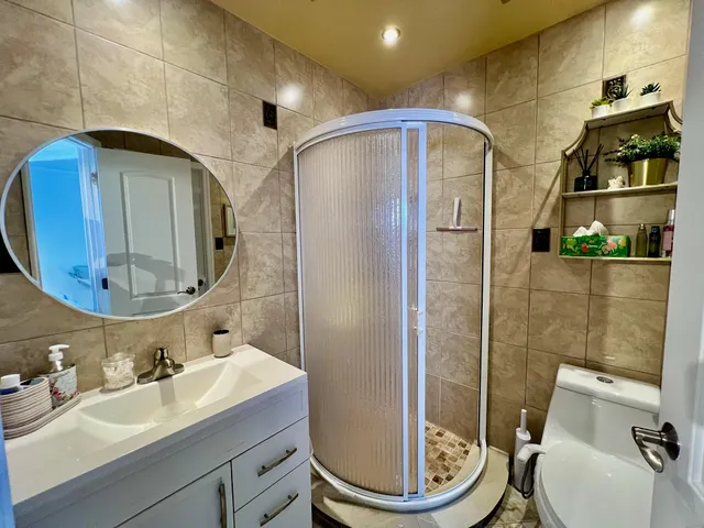 a view of a swimming pool with lawn chairs under an umbrella