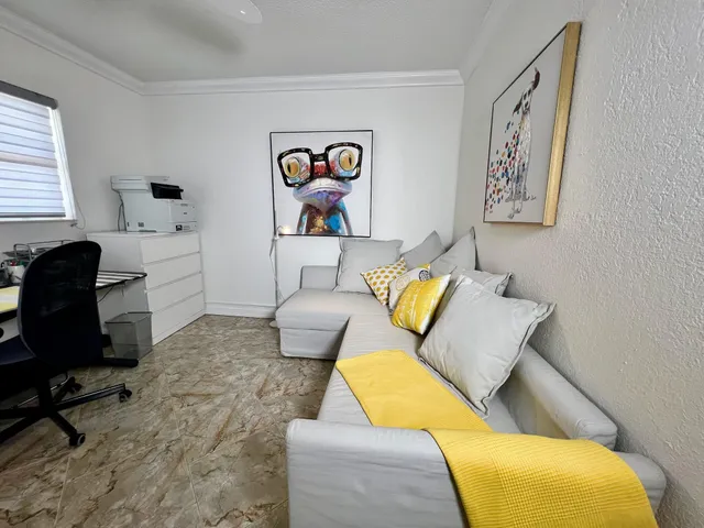 a view of a house with a big yard and potted plants and large trees
