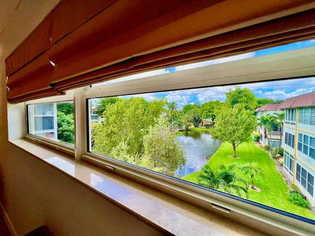 a view of yard with seating area and trees around