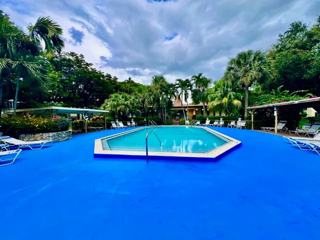 a view of a house with a backyard porch and sitting area