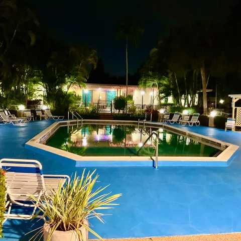 a front view of a house with a yard and fountain