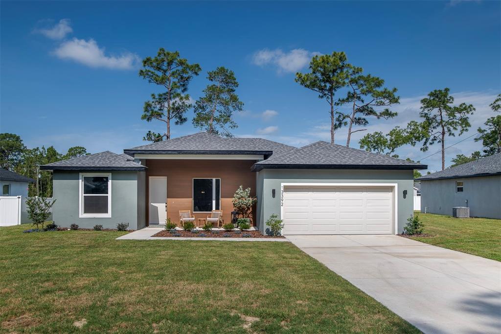 5318 Southwest 116th Place Ocala, FL 34476 - Photo 1 of 1 a front view of a house with garden