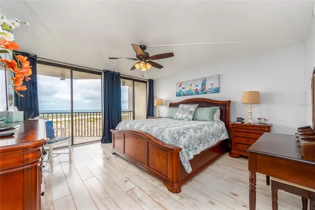 a bedroom with a large bed and a large window