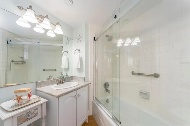a bathroom with a sink a tub and a mirror