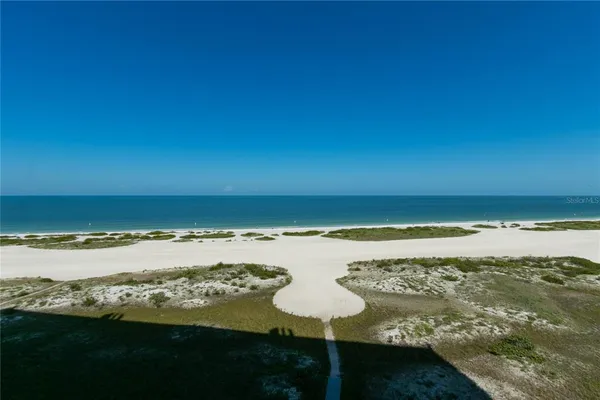 a view of a lake with table and chairs