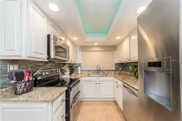a kitchen with a sink a stove and cabinets