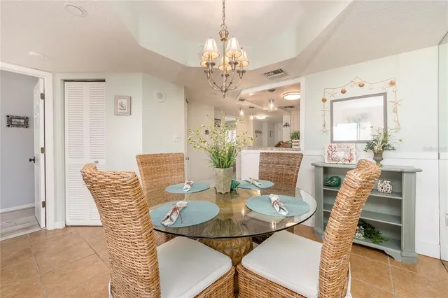 a view of a dining room with furniture and chandelier