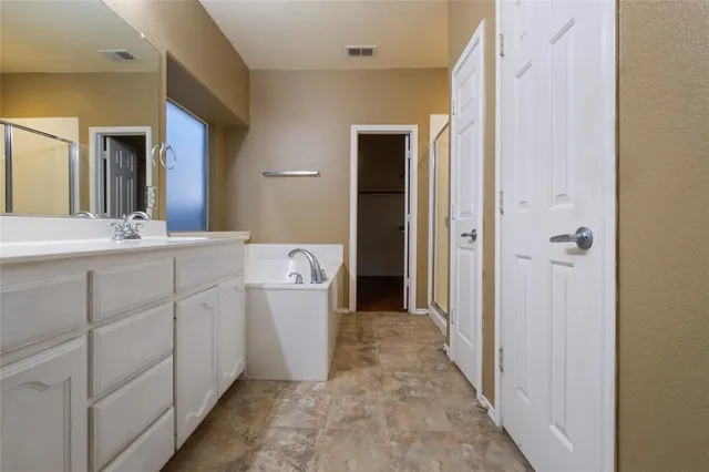 a bathroom with a mirror sink and toilet
