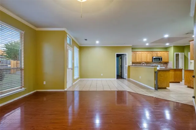 a view of a kitchen with a refrigerator and a sink