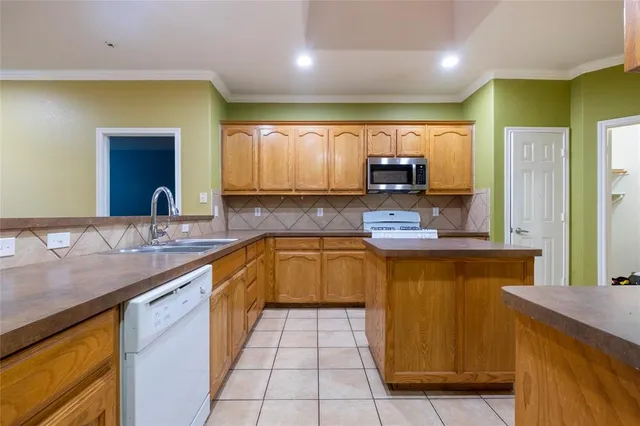 a kitchen with stainless steel appliances granite countertop a sink counter space and cabinets