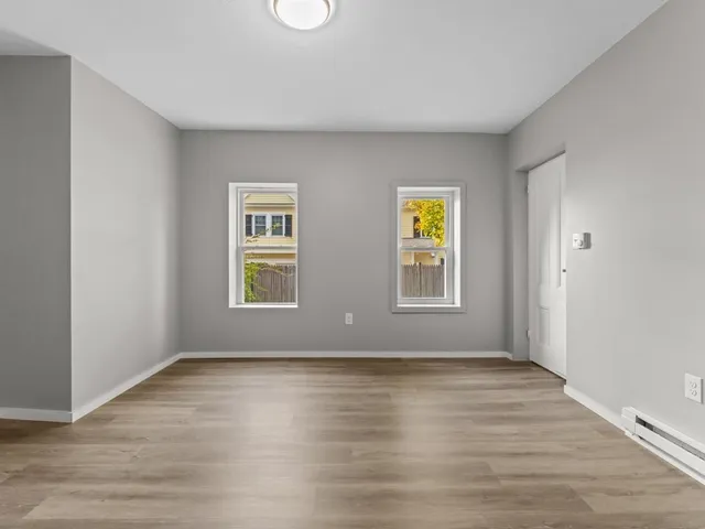 a view of room with wooden floor and window
