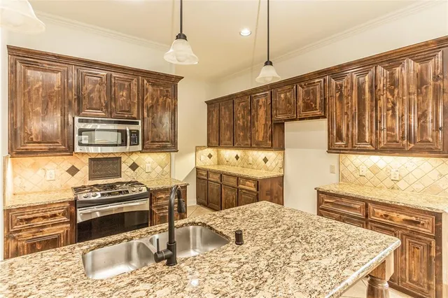 a kitchen with wooden cabinets and a stove top oven