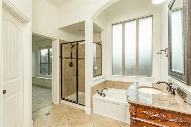a bathroom with a tub sink and mirror