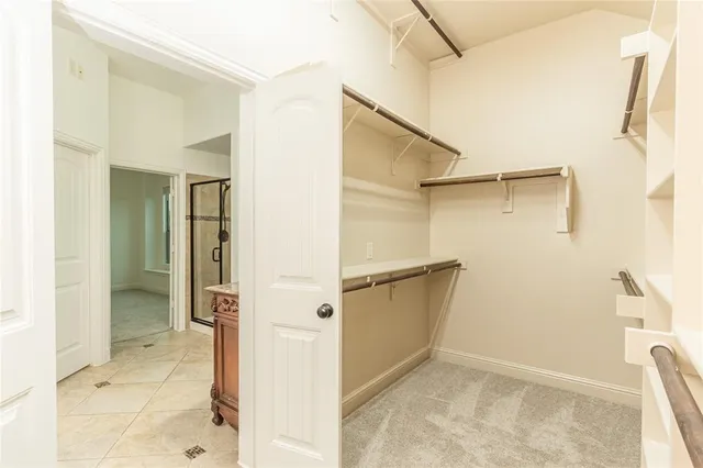a view of walk in closet and bathroom