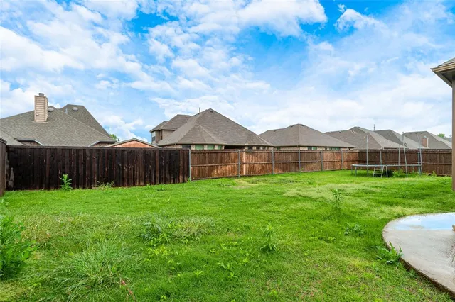 an aerial view of a swimming pool with a yard