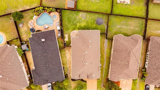 an aerial view of residential house with outdoor space and swimming pool