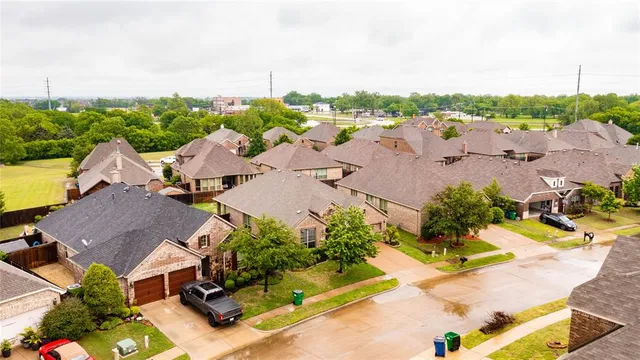 an aerial view of multiple houses with yard