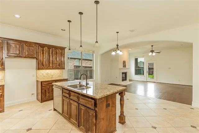 a kitchen with stainless steel appliances granite countertop a sink a stove and a refrigerator
