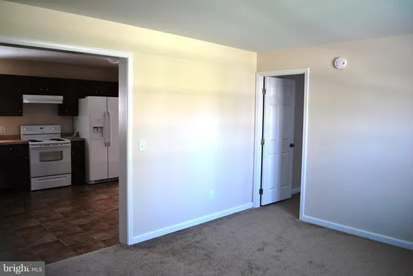 an empty room with a kitchen