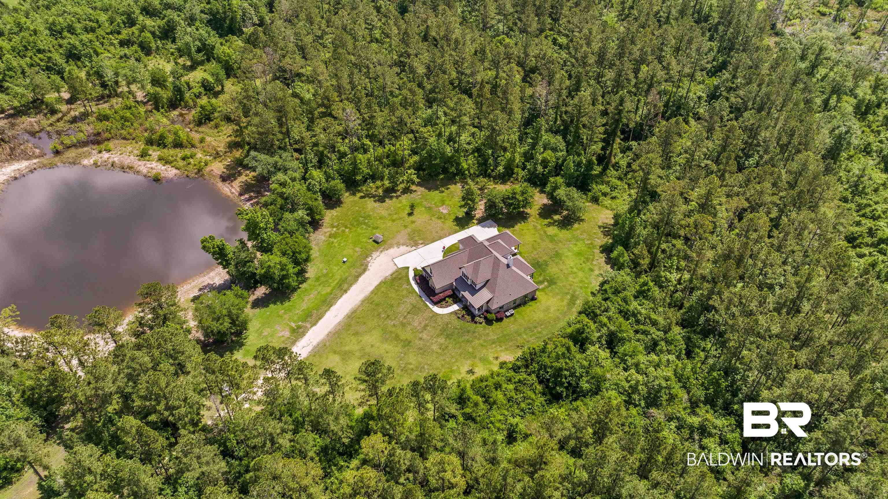 36784 Legacy Way Bay Minette, AL 36507 - Photo 3 of 57 Bird's eye view of a heavily wooded area and a nearby body of water