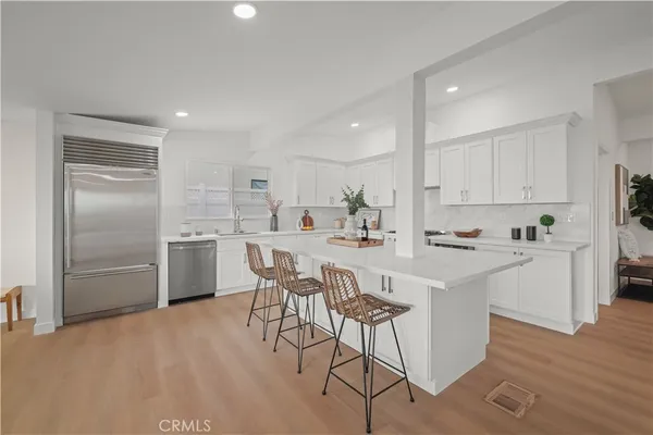 a large kitchen with a table and chairs