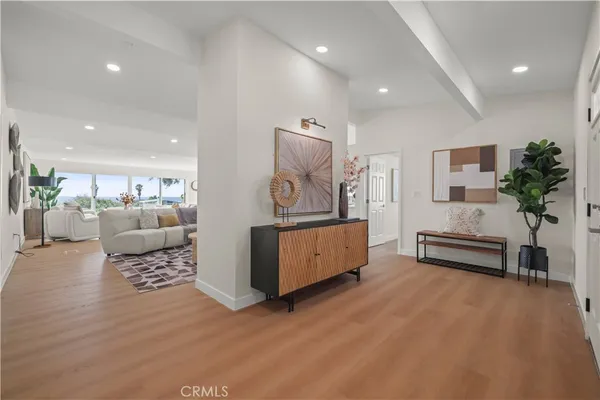 a living room with furniture and view of kitchen