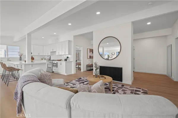 a living room with furniture a mirror and a fireplace