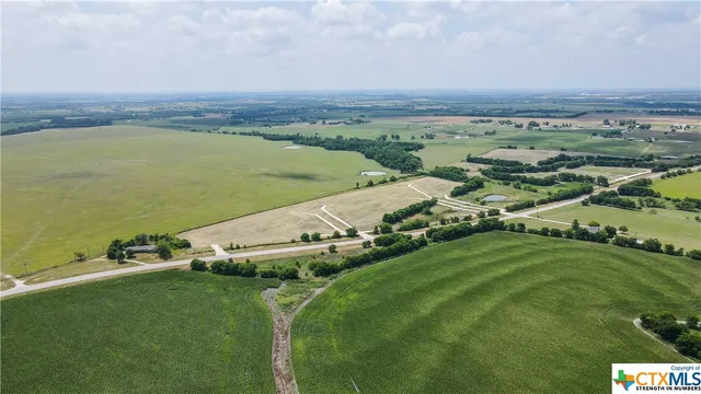 an aerial view of a houses with a yard
