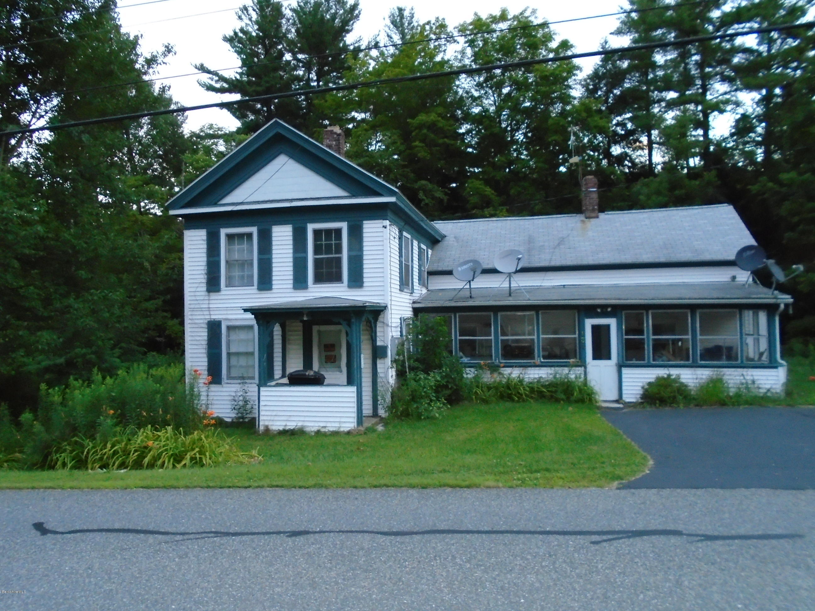 131 Main Road Tyringham, MA 01264 - Photo 2 of 5 a front view of a house with garden