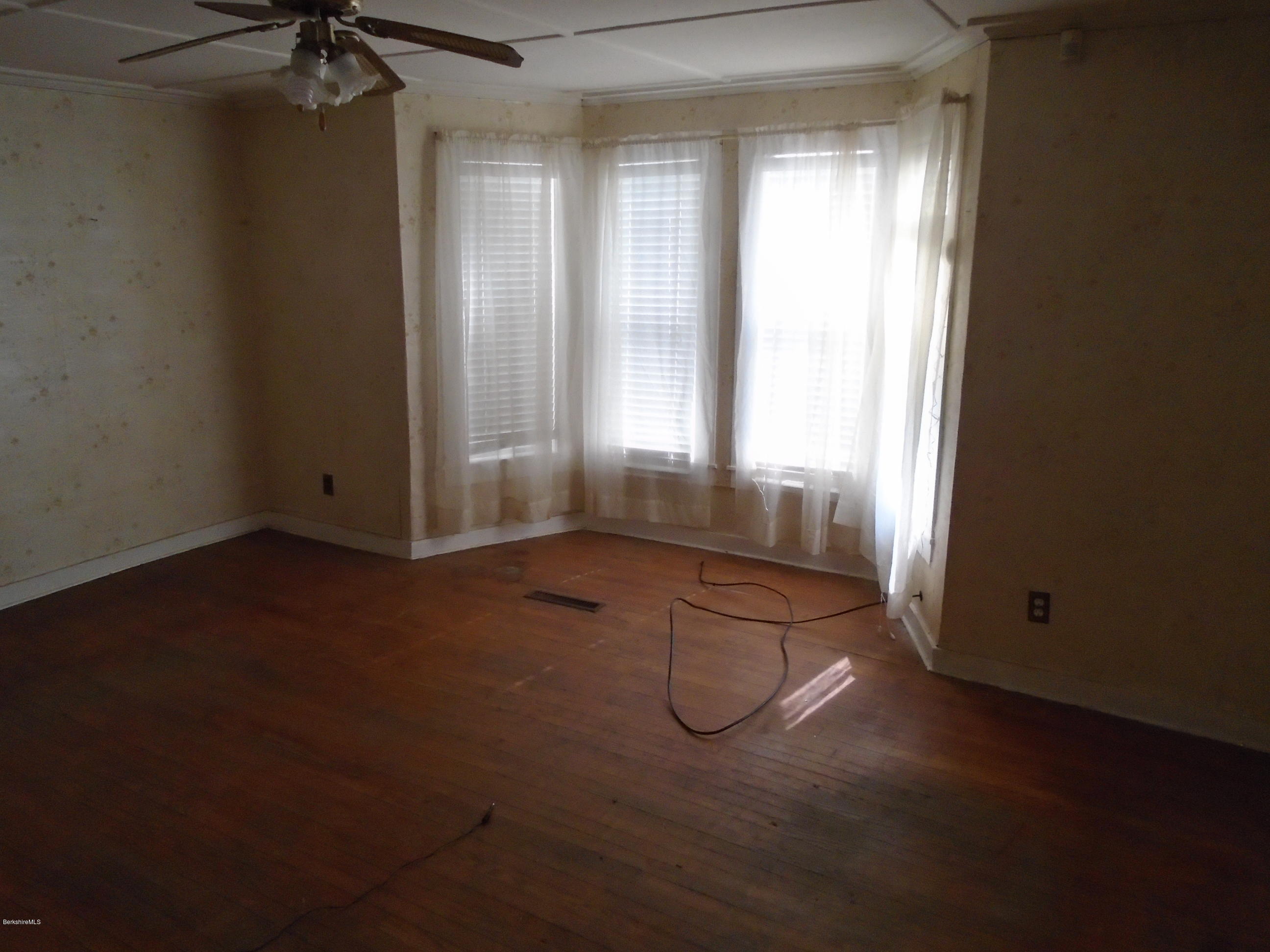 131 Main Road Tyringham, MA 01264 - Photo 4 of 5 an empty room with a empty space and windows